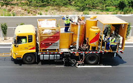 Camion de marquage routier ACE en opération de traçage de ligne blanche sur autoroute